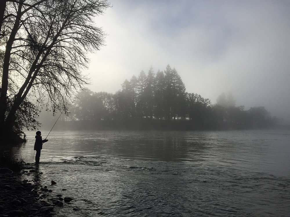 A photo of Sami fishing on a foggy day at River Forks Park